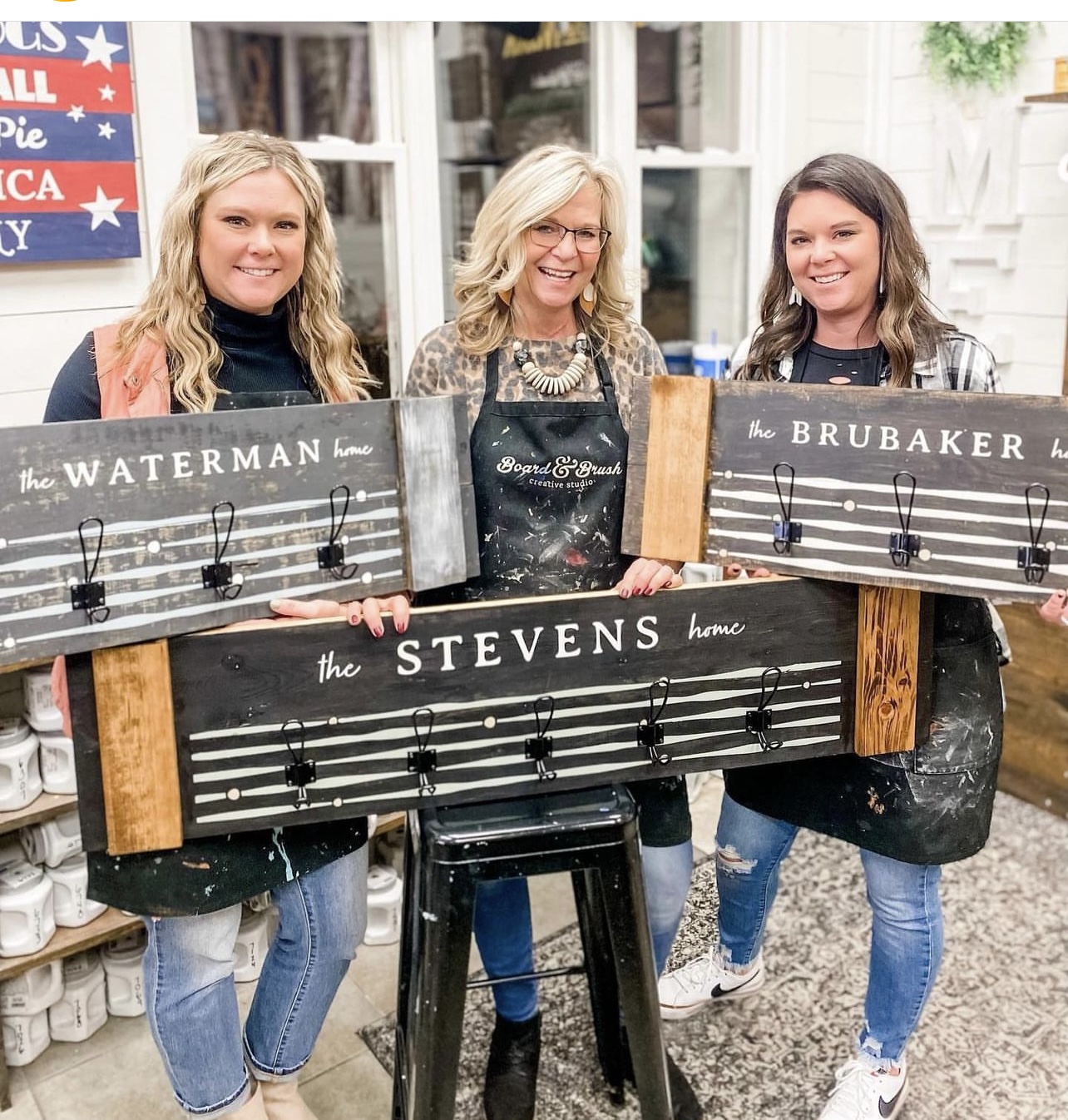 Women pose with signs